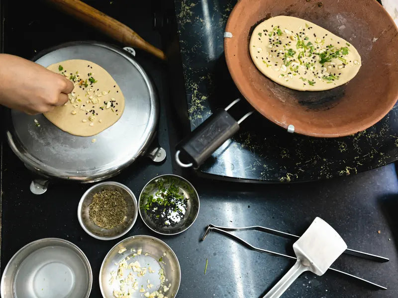 Hands cooking over a stove in a working kitchen